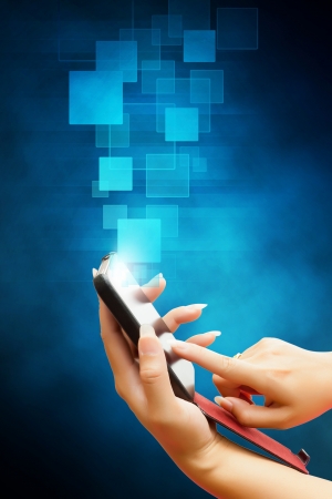 hand of business women pushing on a touch screen interface on smart phone  isolated blue backgroundの写真素材