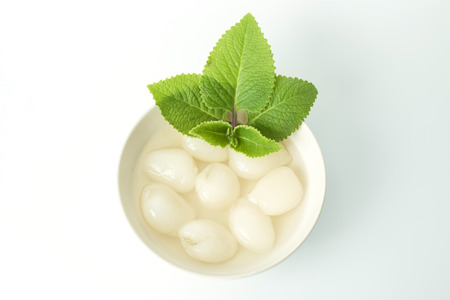 Canned rambutan fruit in cups isolated on white backgroundの写真素材