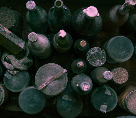 Bird's view of old dusty and spider web covered bottles.の写真素材