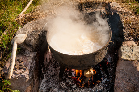 Making cheese the old way. Looks like a witch's kettle boiling with unidentifiable content.の写真素材