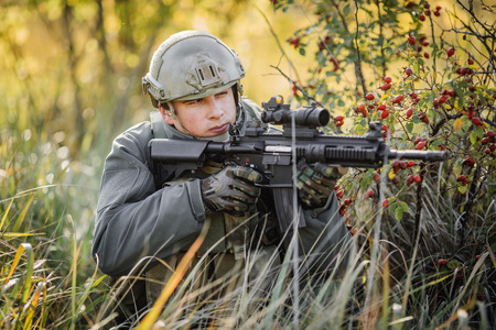 military soldier shooting an assault rifle