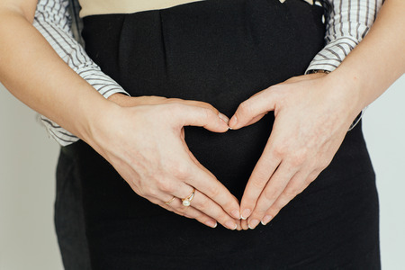 A beautiful young couple hugging and waitnig for the arrival of their babyの写真素材