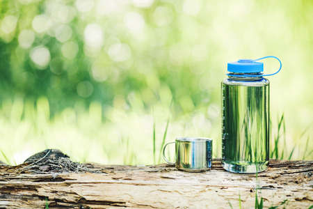 Water bottle on wood  with summer scene backgroundの写真素材