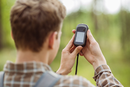 young tourist  in the woods determines location using gpsの写真素材