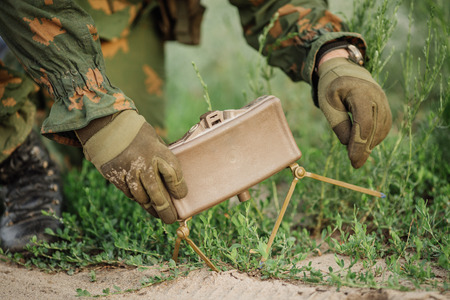 soldiers set mine in the grass next to the roadの写真素材