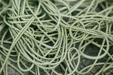 Mess green rope against wood backgroundの写真素材