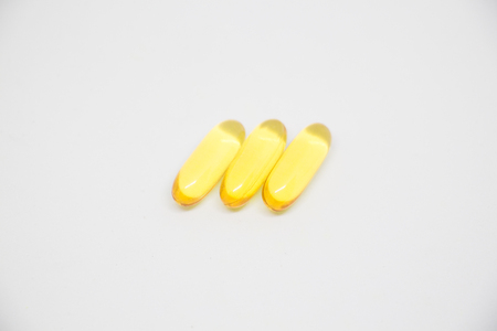 fish oil capsules on a white background close upの写真素材