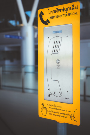 Bangkok Thailand ,yellow public emergency telephones  in airport link .Translation: âemergency telephone,press the button once to call,wait for answer talkâの写真素材