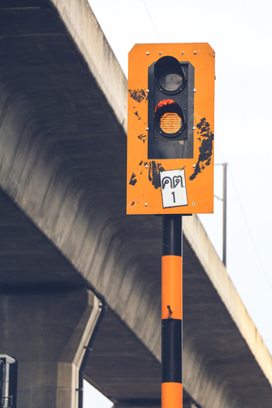 Bangkok Thailand ,Traffic light shows orange signal on railway. orange light, translation :の写真素材