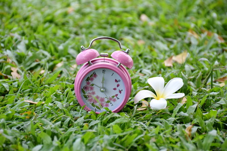 Pink alarm clock outdoors with relaxing time on lunchの写真素材