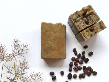 Natural oil soap on white background, coffee bean on top, hot process.の素材