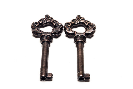 Old ornate skeleton keys isolated on whiteの写真素材