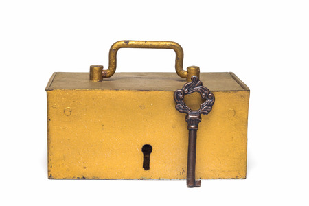 The golden old trunk with the key isolated on a white background の写真素材