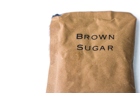 A bag of brown sugar - isolated over white backgroundの写真素材