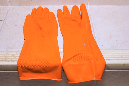 Orange rubber gloves on the floor
