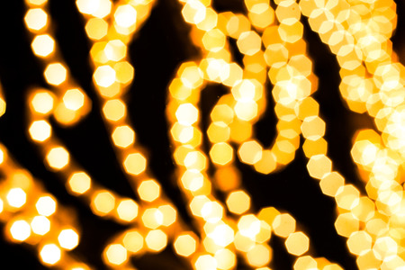 Gold pentagon bokeh on black backgroundの写真素材
