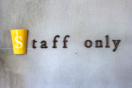 The word "staff only" on a cement wallの写真素材
