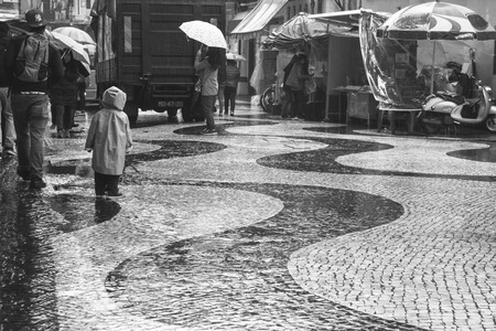 MACAU, CHINA - DEC 9, 2015: Cityscape of Macau, people are walking. Located in St. Dominic's Church, Macau. It is a Historic Centre of Macau, a UNESCO World Heritage Site. It's rainy season.のeditorial素材