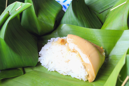 Thai dessert, Sticky rice with steamed custard, wrapped in banana leafの写真素材