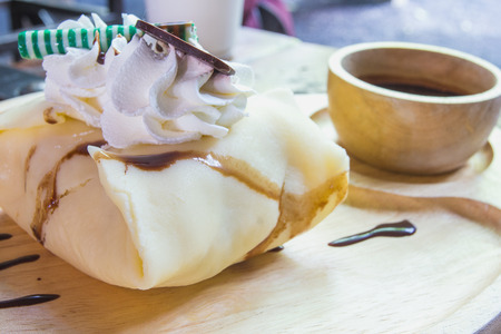 Waffles with banana, chocolate syrup and coffeeの写真素材