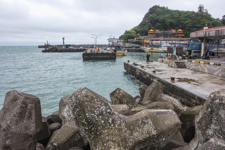 YEHLIU, TAIWAN - OCT11, 2016: Tourists at the Yeliu (Yehliu) Geopark in Wanli District, New Taipei, Taiwan at a rainy, windy and overcast day.のeditorial素材