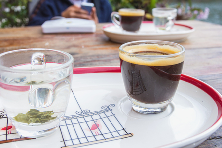 Cup of black coffee with hot tea.の写真素材