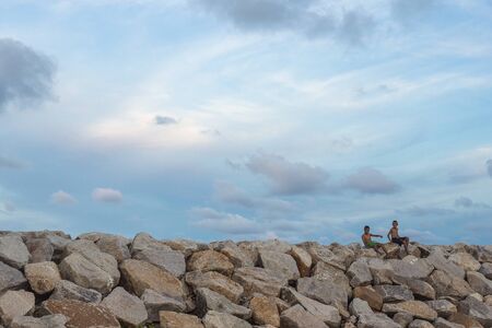 SONGKHLA, THAILAND - NOV17, 2017 : Children playing on the rocks at beach in Songkhla province, Thailand.のeditorial素材