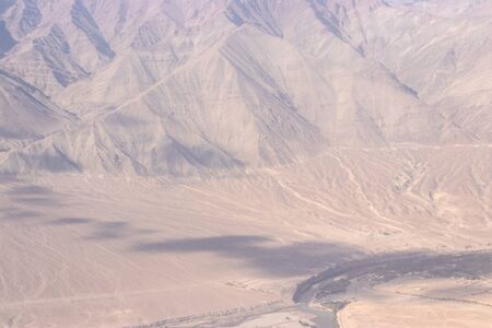 View of the Himalayas mountain through airplane window.