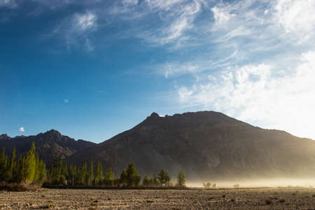 Stunning light and beautiful mist on sunrise background at Nubra valley, Leh Ladakh, India.  Scence...