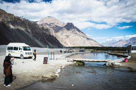 LEH LADAKH, INDIA - JUN18, 2018: Tourist travel to visit beautiful sand dune with high mountain background at Nubra valley, Leh Ladakh, India.のeditorial素材