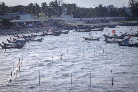 SONGKHLA, THAILAND - OCT23, 2018: Vintage image of fishermen are putting fish trap near local boats, Songkhla province, Thailand.のeditorial素材