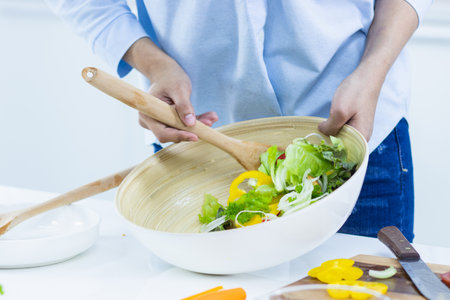 Woman cooking vegetable salad for dieting.の写真素材