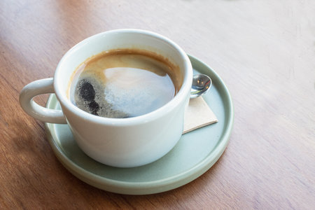 Cup of black coffee on wooden table.の写真素材