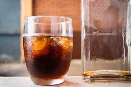 Cold-brewed coffee in a clear glass with a clear bottom.の写真素材