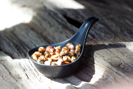 almonds on black a spoon.
