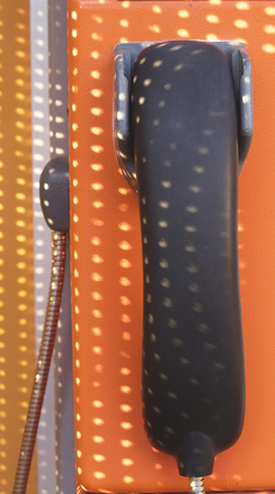 orange telephone receiver with shawdow light.の写真素材