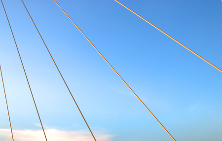 A rope bridge and blue skyの写真素材