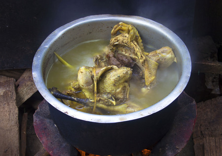 I make chicken broth in a pot by fireplaceの写真素材