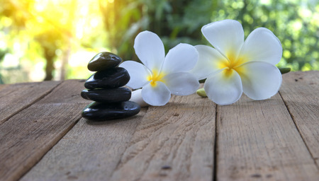 flower frangipani on wood background and stone spa.の写真素材