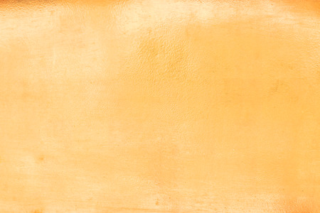 Shiny yellow leaf gold foil texture background.