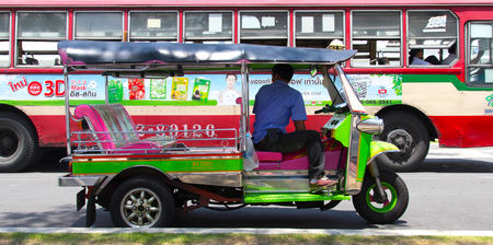 Bangkok, Thailand - 14 September, 2017: People and Tuk-Tuks on the Road, in the late afternoon