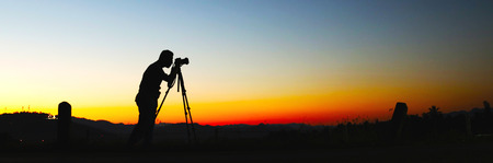 Photographers, silhouette of photographers and sunset.