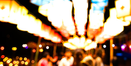 image of party in front of abstract blurred background of resturant lightsの写真素材