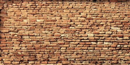 Antique brown brick wall of red color.texture grunge background.may use to interior designの写真素材
