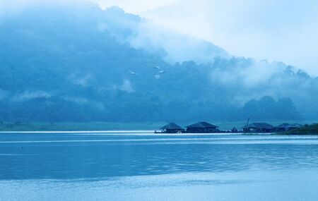 Mountains, hut, lakes and the early morning fog.の写真素材