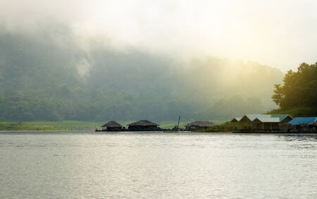 Mountains, hut, lakes and the early morning fog.の写真素材