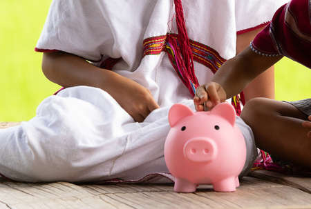 High ground child saving money in piggy bank.の写真素材