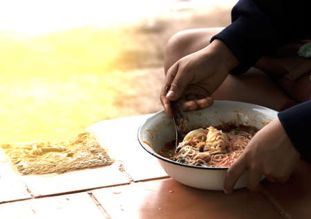 Feeding the poor to hands of a beggar. Poverty concept.の写真素材