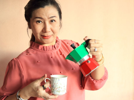 Female making better coffee with Moka Potの写真素材