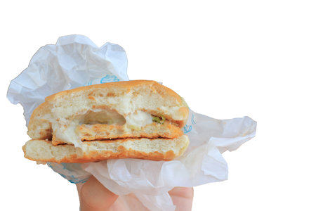 Sandwich with chicken and cheese in hand isolated on white background.の写真素材